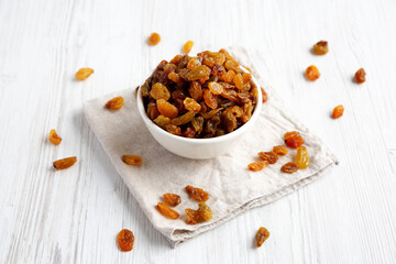 Organic Dried Raisins in a White Bowl, side view.