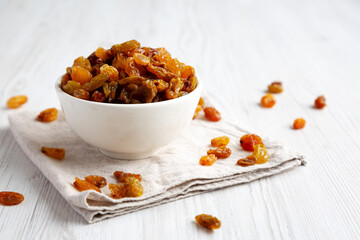 Organic Dried Raisins in a White Bowl, low angle view.