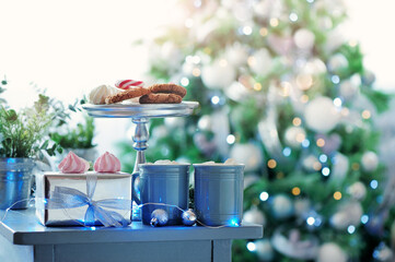 Still life of desserts against christmas tree background