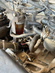 Horizontal view of a car hood with dusty and rusty parts.