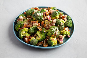 Homemade Broccoli Bacon Salad on a Plate on a gray background, side view.