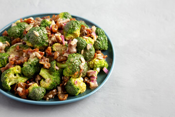 Homemade Broccoli Bacon Salad on a Plate on a gray background, side view. Copy space.