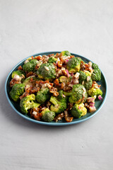 Homemade Broccoli Bacon Salad on a Plate on a gray background, side view.