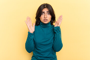 Young Indian woman isolated on yellow background having an idea, inspiration concept.