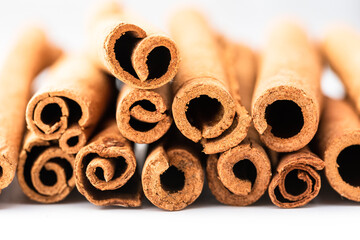 Close-up cinnamon sticks on white background.