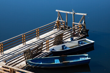 Fototapeta na wymiar two boats tied to a wooden dock
