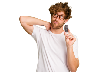 Young caucasian man holding car keys isolated on white background touching back of head, thinking and making a choice.
