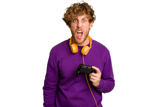 Young caucasian gamer man holding a game controller isolated on white background screaming very angry and aggressive.