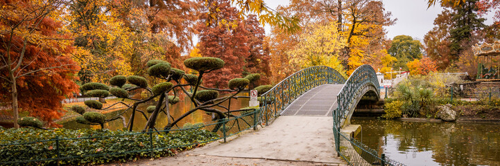 Iron footbridge in the Jardin Public park in Autumn in Bordeaux, France