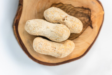 Three peanuts on wood