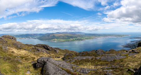 Panoramic photo of Slieve Donard slieve Bearnagh and Slieve Binnian  Mountains Carlingford Lough Louth Ireland.. Rocks in foreground.