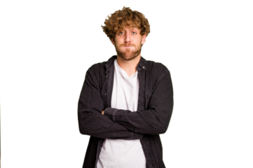 Young caucasian man isolated on green chroma background blows cheeks, has tired expression. Facial expression concept.