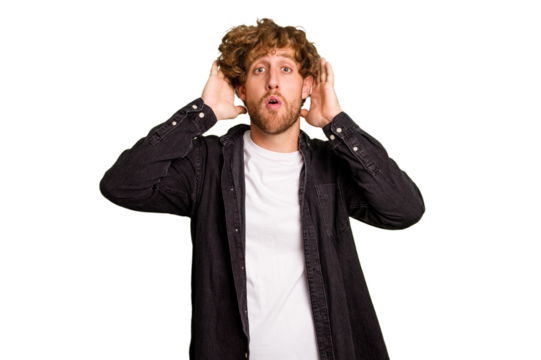 Young caucasian man isolated on green chroma background being shocked, she has remembered important meeting.