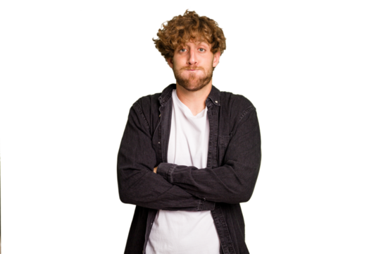 Young caucasian man isolated on green chroma background blows cheeks, has tired expression. Facial expression concept.