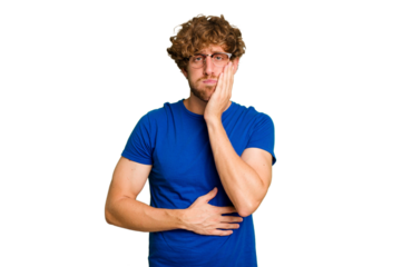 Young caucasian man isolated on green chroma background blows cheeks, has tired expression. Facial expression concept.