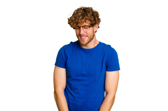 Young caucasian man isolated on green chroma background laughs and closes eyes, feels relaxed and happy.