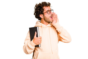Young caucasian student man isolated shouting and holding palm near opened mouth.