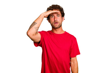Obraz premium Young caucasian curly hair man isolated Young caucasian man with curly hair isolated shouts loud, keeps eyes opened and hands tense.