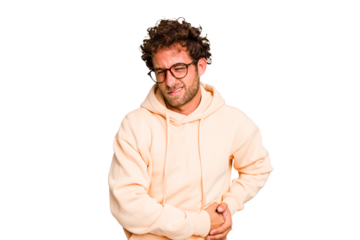 Young caucasian curly hair man isolated Young caucasian man with curly hair isolated having a liver pain, stomach ache.