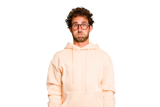 Young caucasian curly hair man isolated Young caucasian man with curly hair isolated blows cheeks, has tired expression. Facial expression concept.