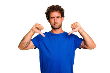 Young caucasian curly hair man isolated Young caucasian man with curly hair isolated showing thumb down, disappointment concept.