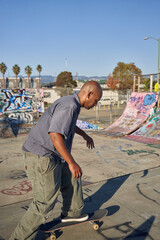 Portrait of young man riding  in skateboard at skatepark  © Sheilby Macena