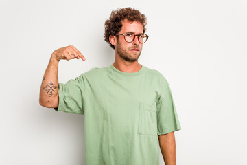 Young caucasian curly hair man isolated on white background person pointing by hand to a shirt copy space, proud and confident