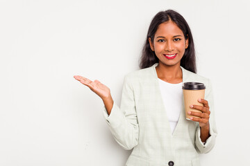 Young business Indian woman holding takeaway coffee isolated on white background showing a copy...