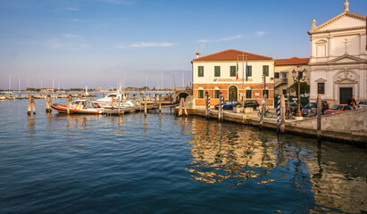 Boat of the Guardia Costiera (Italian coastguard) moored near yachts in the harbour at Chioggia Venetian Lagoon, Veneto regione, Italy, Europe – october 30, 2021