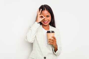 Young business Indian woman holding takeaway coffee isolated on white background excited keeping ok gesture on eye.