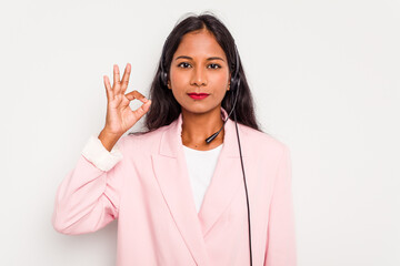 Telemarketer Indian woman working with a headset isolated on white background with fingers on lips keeping a secret.