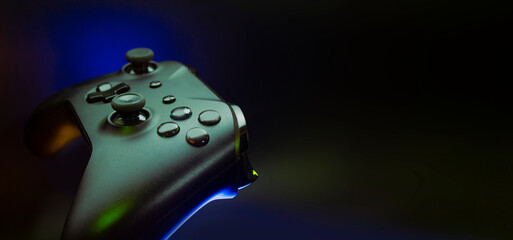 gamer playing the online game with joystick controller in neon glow dark cyberpunk room, gaming and...