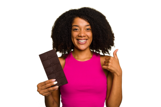 Young African American woman holding a chocolate bar isolated smiling and raising thumb up