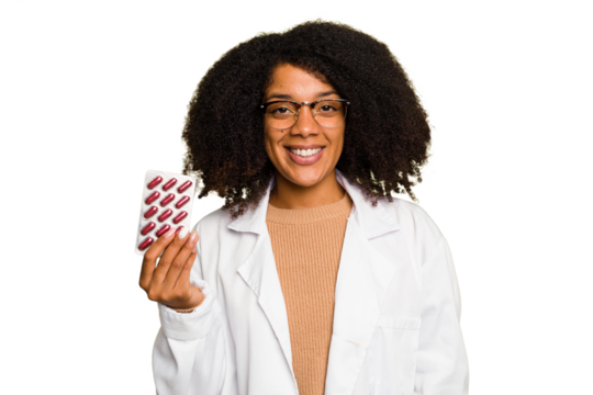 Young pharmacist African American woman holding a tablet of pills isolated happy, smiling and cheerful.