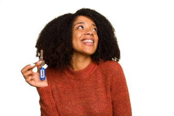 Young African american woman holding home keys isolated dreaming of achieving goals and purposes