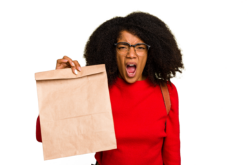 Young African american woman holding take away food isolated screaming very angry and aggressive.