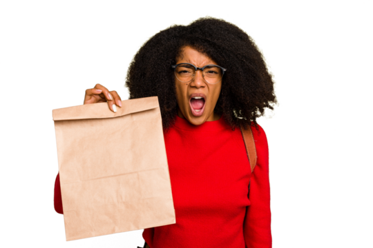 Young African american woman holding take away food isolated screaming very angry and aggressive. - Powered by Adobe