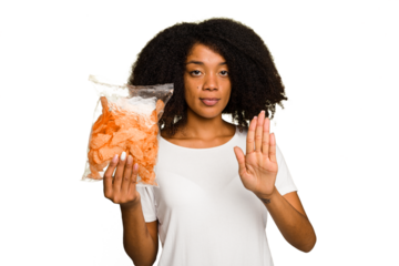 Young African american man holding crips isolated standing with outstretched hand showing stop sign, preventing you.