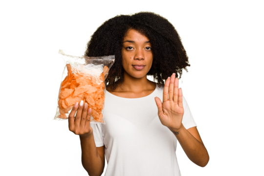 Young African american man holding crips isolated standing with outstretched hand showing stop sign, preventing you. - Powered by Adobe