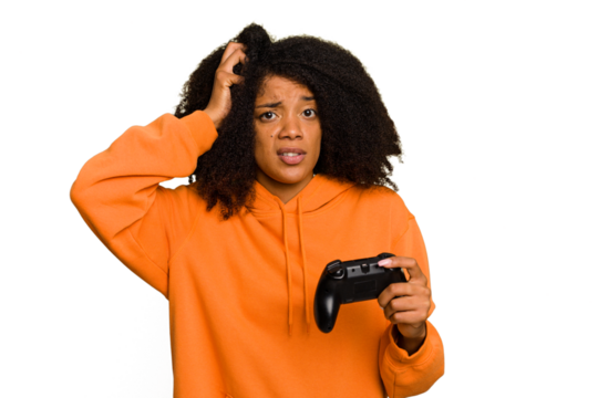 Young African American woman holding a game controller isolated being shocked, she has remembered important meeting.