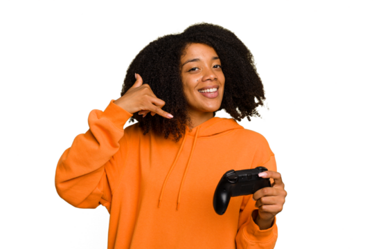 Young African American woman holding a game controller isolated showing a mobile phone call gesture with fingers.