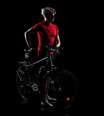 Mountain biker with his bicycle silhouette full length portrait