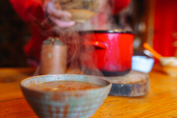 Hot beetroot soup in shabby ceramic bowl