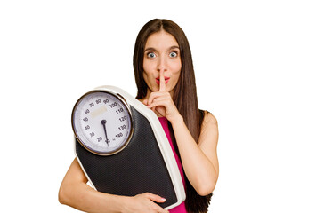 Young caucasian woman holding a scale isolated keeping a secret or asking for silence.