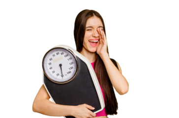 Young caucasian woman holding a scale isolated shouting and holding palm near opened mouth.