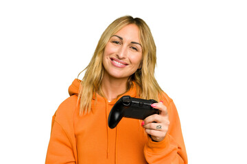 Young caucasian gamer woman holding a game controller isolated on green chroma background happy,...