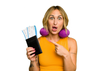 Young caucasian woman with inflatable travel pillow holding passport isolated on green chroma background pointing to the side