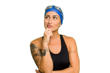 Young caucasian swimmer woman isolated on green chroma background looking sideways with doubtful and skeptical expression.