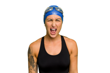 Young caucasian swimmer woman isolated on green chroma background screaming very angry and aggressive.