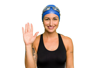 Young caucasian swimmer woman isolated on green chroma background smiling cheerful showing number five with fingers.